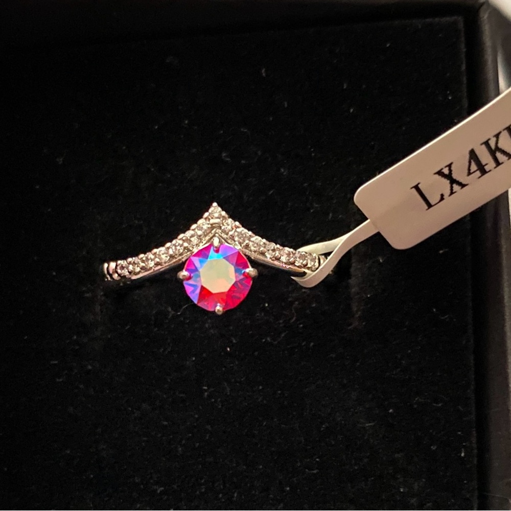 Charm Aroma silver ring with pink aurora borealis style stone.